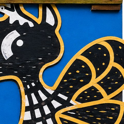The hand-painted bird emblem from the museum's Visitor Info sign